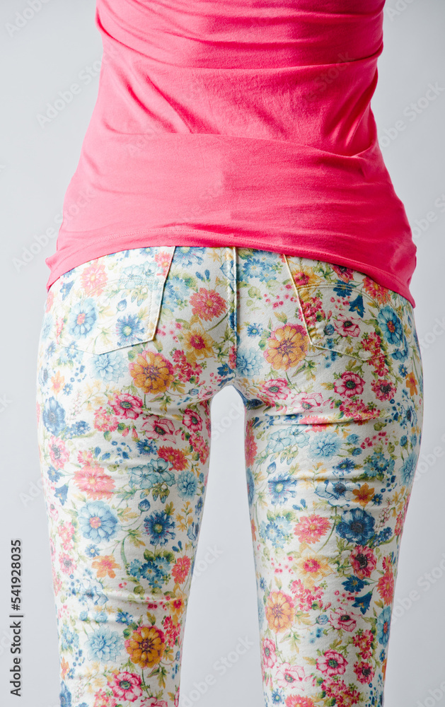 Floral print pants. Bright pants on a beautiful female figure. Floral print. Pink mood. Beautiful female butt. Women’s shopping