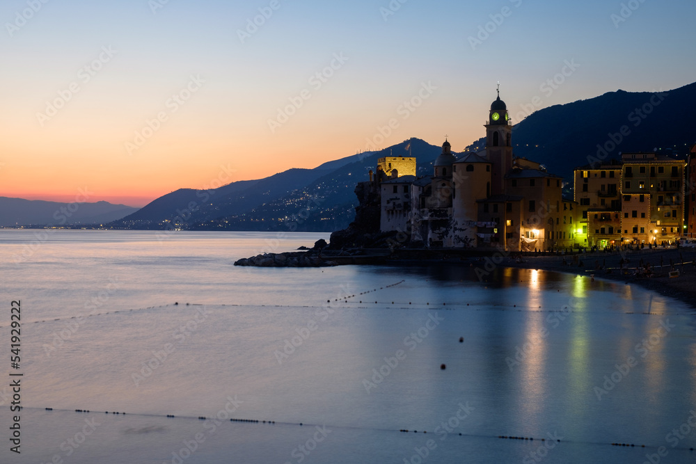 Blue hour at the coastline of Camogli, Liguria Italy, with the basilica of Santa Maria Assunta.