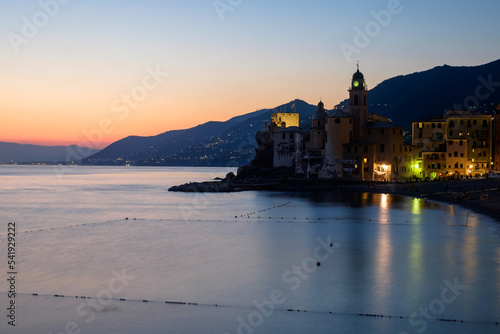 Blue hour at the coastline of Camogli, Liguria Italy, with the basilica of Santa Maria Assunta.