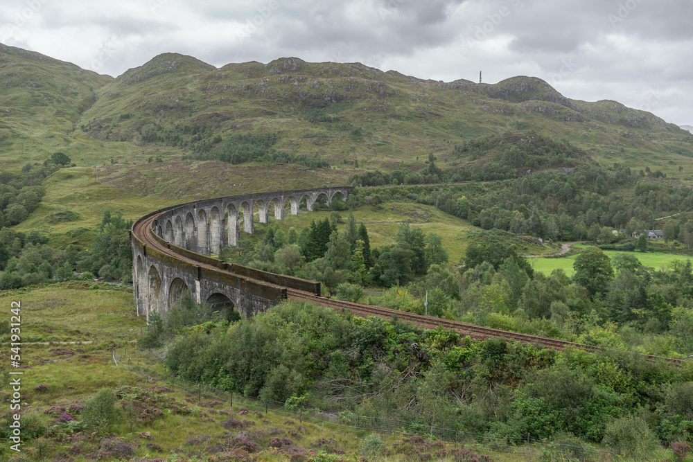 Railway viaduct curving through the Glenfinnan landscape in scotland