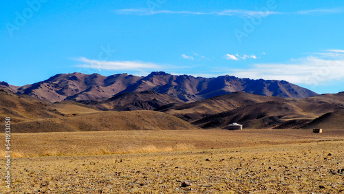 Ger in Mongolia countryside with mountains in the background 