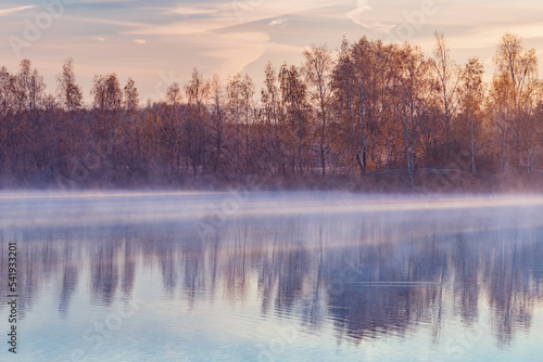 Fog above the lake at cold morning.