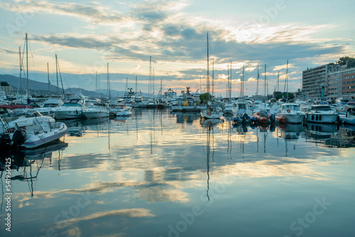 Morning view with rising sun in clouds  on Harbor   with yachts in parking lots  and district Monte Carlo © Marat Lala