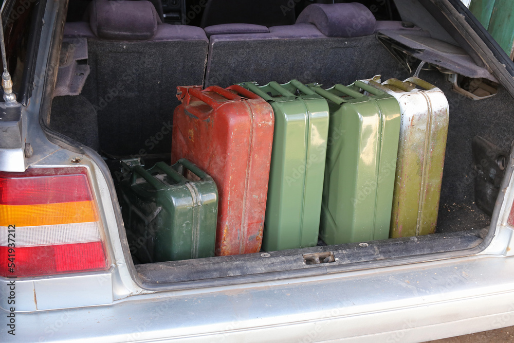 Cans of gasoline in the trunk of a car. Lack of petrol at gas stations. Cans of gasoline in the trunk of a car. Lack of petrol at gas stations.