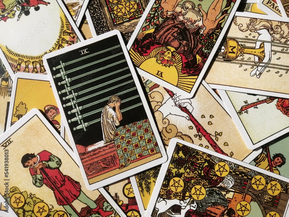 Obraz premium Picture of the Nine of Swords tarot card from the original Rider Waite tarot deck with mixed tarot cards in the background