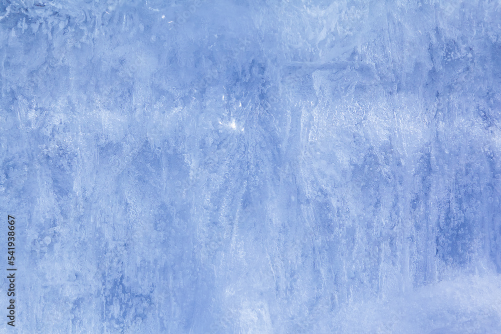 Texture of winter ice on a stone cliff. Blue natural ice background Texture of winter ice on a stone cliff. Blue natural ice background