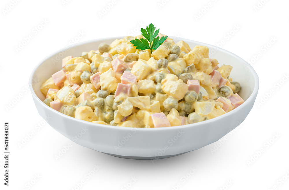 The traditional olivier salad with vegetables and fresh herbs is isolated on a white background. Side view, close-up. The traditional olivier salad with vegetables and fresh herbs is isolated on a white background. Side view, close-up.