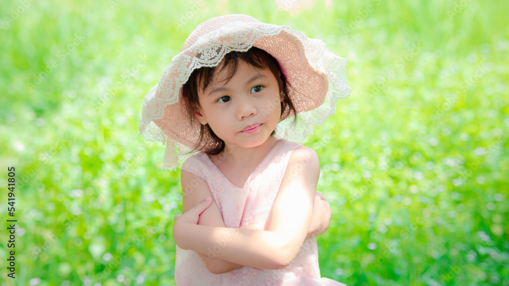 Positive charming 4 years old cute baby Asian girl, little preschooler child with adorable short hair smiling and looking to the right. Copy space. Positive charming 4 years old cute baby Asian girl, little preschooler child with adorable short hair smiling and looking to the right. Copy space.