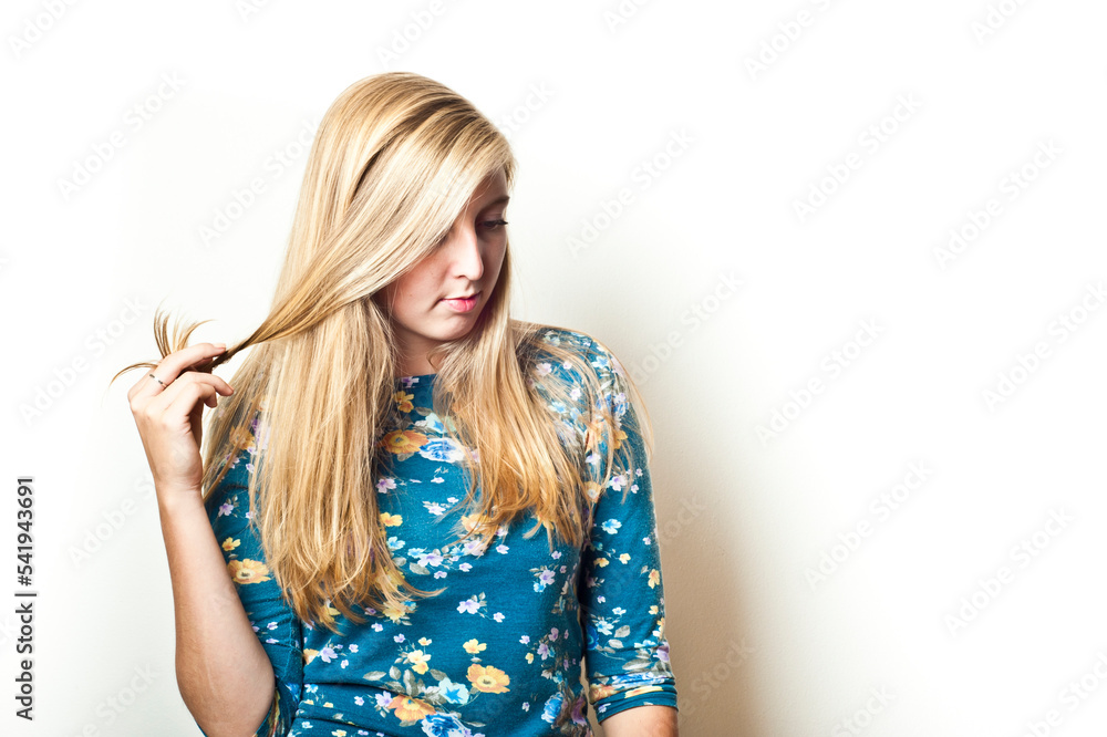 blonde young woman Caucasian touching her hair blonde young woman Caucasian touching her hair