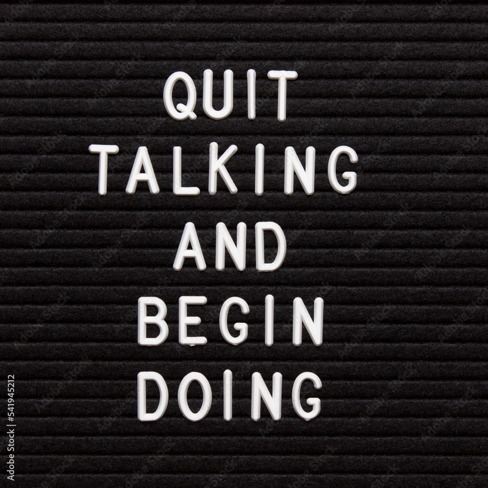 Motivational quote on black letter board. Quit talking and begin doing. Inspirational quote of the day. Motivational quote on black letter board. Quit talking and begin doing. Inspirational quote of the day.