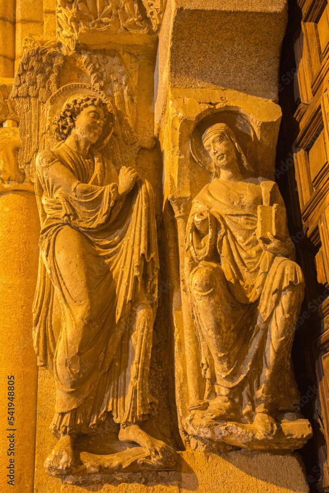 AVILA, SPAIN, APRIL - 19, 2016: The Annunciation sculpture on the left part of romanesque south portal of Basilica de San Vicente with the apostles (1130).
