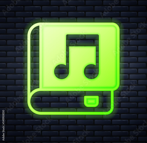 Glowing neon Audio book icon isolated on brick wall background. Musical note with book. Audio guide sign. Online learning concept. Vector