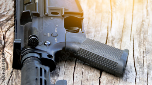 Close up pistal grip of black BB gun, soft and selective focus photo