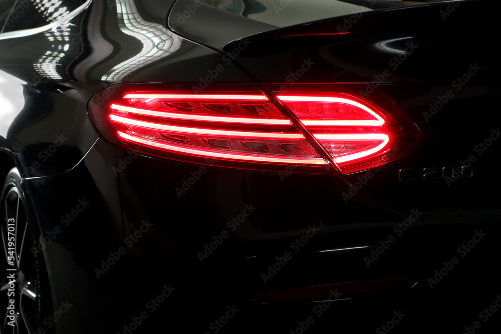 nice design led tail light or tail lamp of black sports brand Mercedes Benz c200 coupe model park in the garage during checking and maintenance process Stock Photo | Adobe