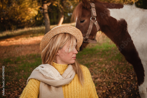 Beautiful picture, autumn nature, woman and horse, concept of love, friendship and care. background. unusual portrait