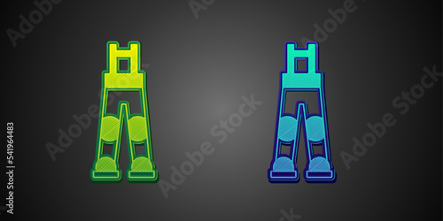 Green and blue Fisherman rubber pants icon isolated on black background. Vector