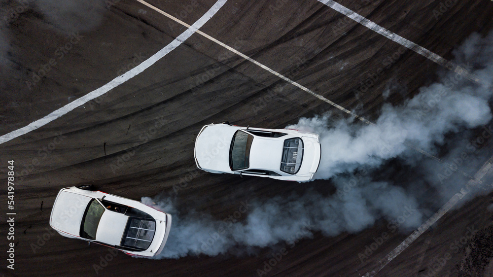 Aerial top view car drifting, Race drift car with lots of smoke from  burning tires on