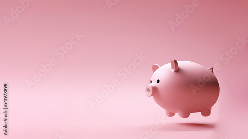 concetto di risparmio con salvadanaio a forma di maialino sospeso in un rendering rosa photo