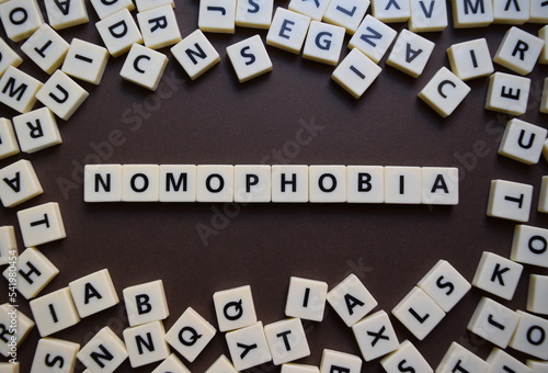 Letters spelling out nomophobia photo