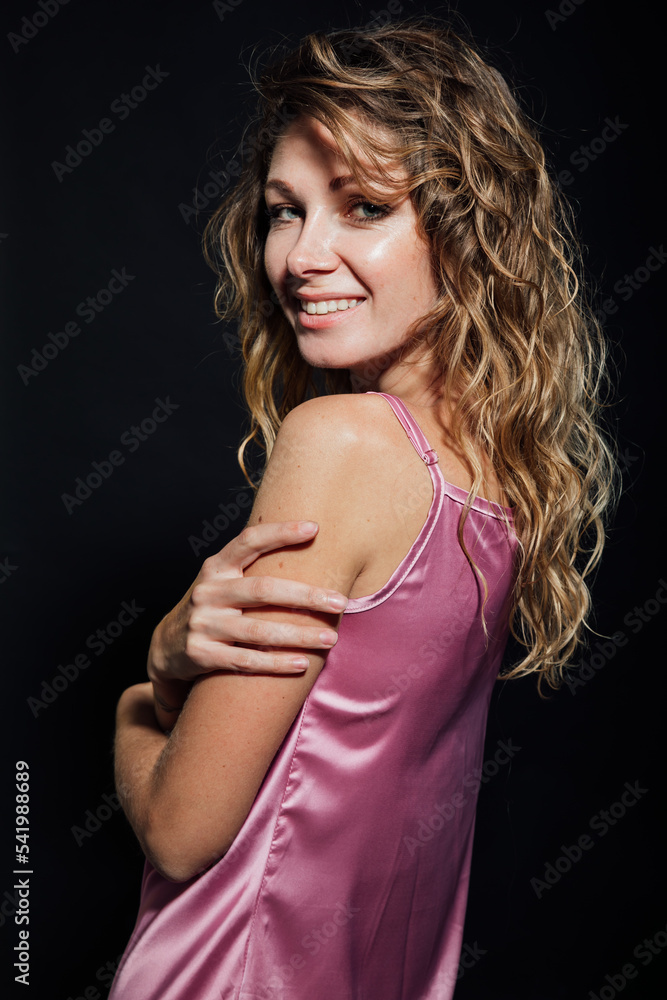 Naklejka premium portrait of a beautiful blonde woman in a pink silk dress