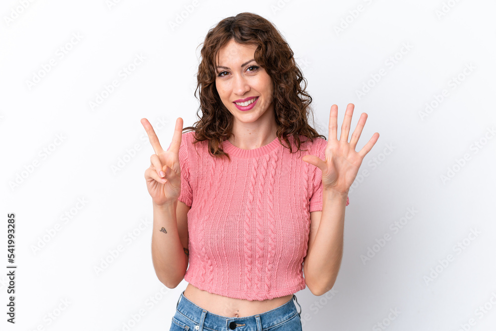 Young woman with curly hair isolated on white background counting seven with fingers Young woman with curly hair isolated on white background counting seven with fingers