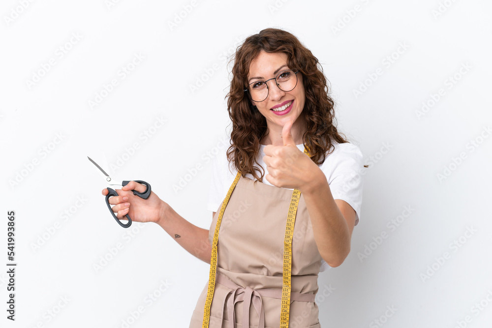 Young caucasian seamstress woman isolated on white background with thumbs up because something good has happened Young caucasian seamstress woman isolated on white background with thumbs up because something good has happened