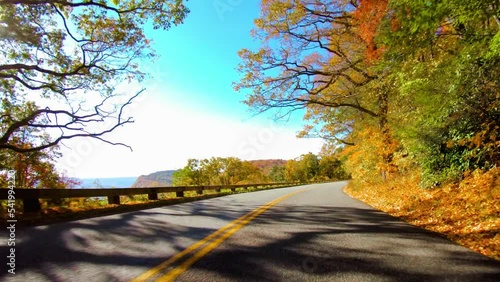 driving at the Blue Ridge Parkway, North Carolina on sunny autumn day. Vibrant fall park forest
