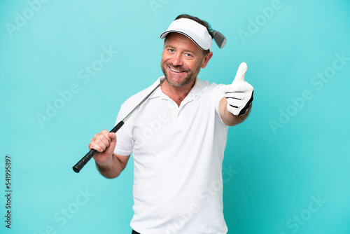 Middle age caucasian golfer player man isolated on blue background with thumbs up because something good has happened