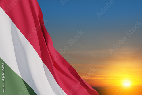 Waving flag of Hungary in sunset sky. Independence day, National day. Background with place for your text. 3d-rendering. photo