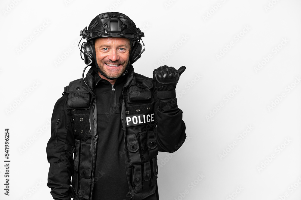 Middle age SWAT man isolated on white background pointing to the side to present a product Middle age SWAT man isolated on white background pointing to the side to present a product