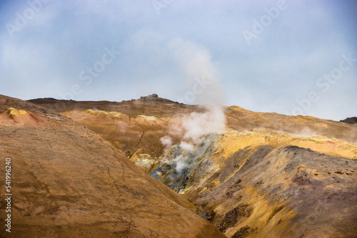 Hverir and myvatn geothermal spot with bubbling mud and steaming fumaroles emitting sulfuric gas.