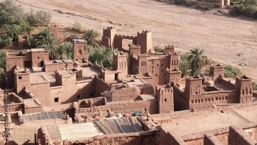 High angle view of the Ksar Kasbah Ait Benhaddou. A rural village with old clay houses, authentic traditional South Moroccan country-style adobe architecture. 4k footage.  photo