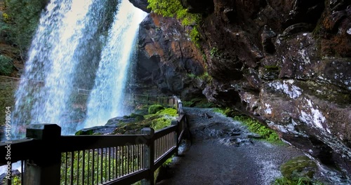 Dry Falls Waterfall, Nantahala National Forest, North Carolina. tourist attraction, a trail behind the natural waterfall in Appalachian mountains photo