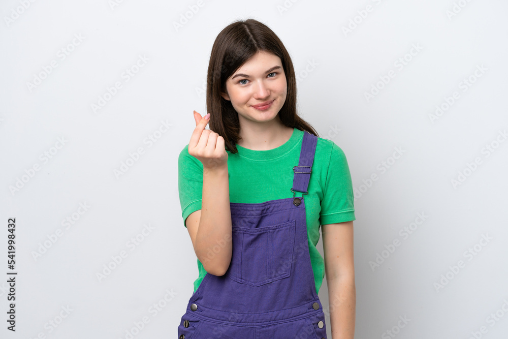 Young Russian woman isolated on blue background making money gesture Young Russian woman isolated on blue background making money gesture