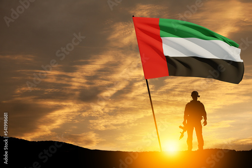 Bilde på lerret Silhouette of soldier with the flag of UAE against sunset or sunrise