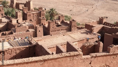 High angle view of the Ksar Kasbah Ait Benhaddou. A rural village with old clay houses, authentic traditional South Moroccan country-style adobe architecture. 4k footage.