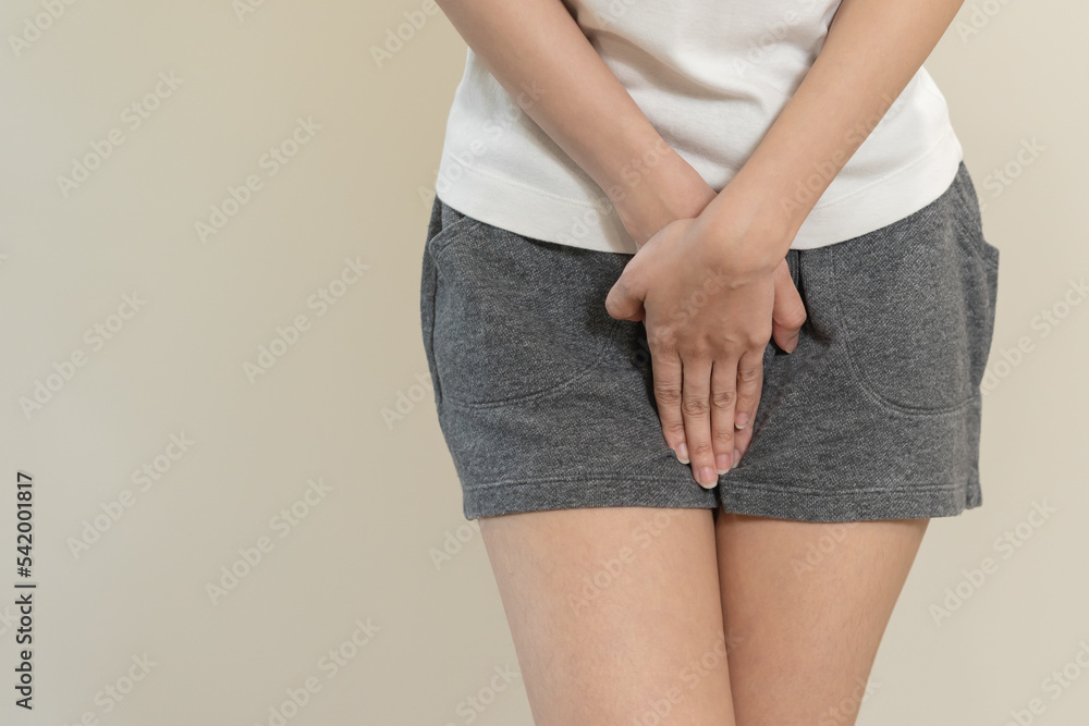 Vaginal, urinary incontinence. Pain asian young woman hand holding