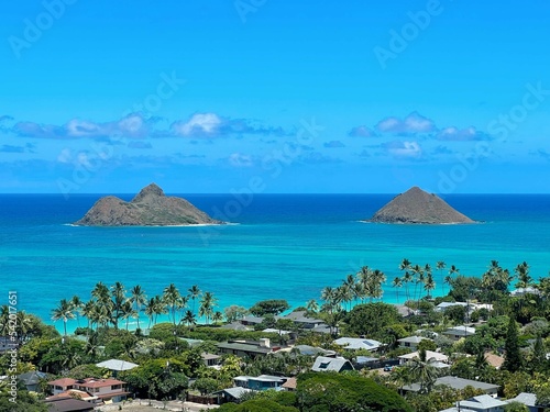Mokulua Islands and Lanikai Beach in Hawaii against a blue sky