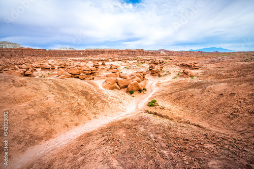 Hiking trail path at Goblin valley state park, Utah with nature desert valley landscape and hoodoo sandstone rock formations showing canyon erosion