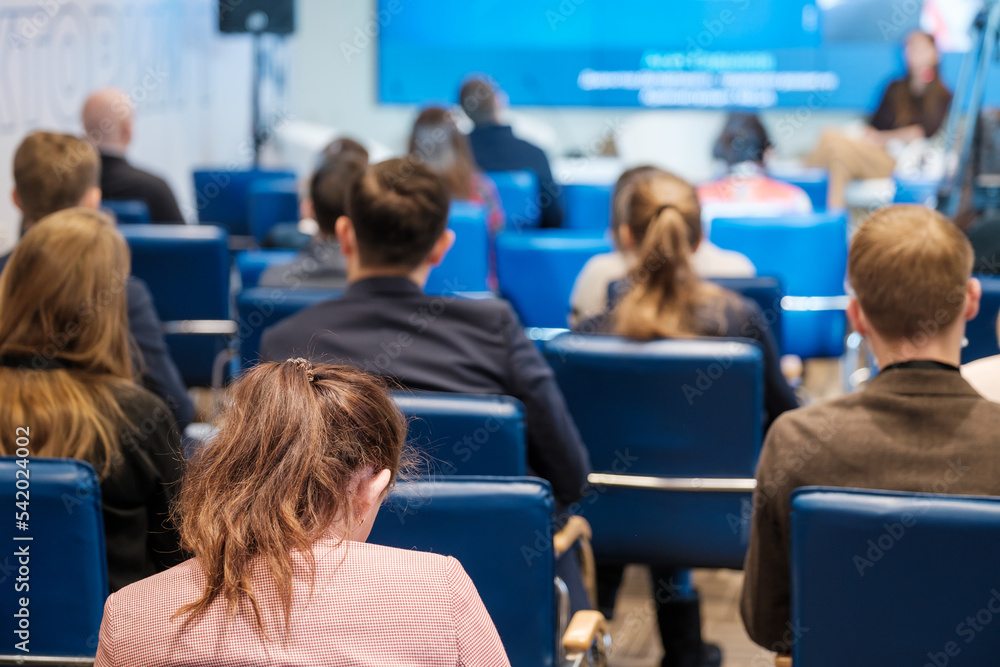 Fototapeta premium Woman during business seminar in auditorium