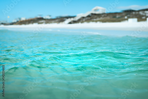 Relaxing view from inside water on coast shore beach with turquoise blue water waves at Gulf of Mexico ocean sea in Seaside, Florida panhandle photo