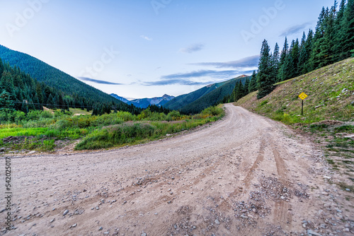 Canvas Print View of green alpine mountains with dirt country rural countryside road to Ophir