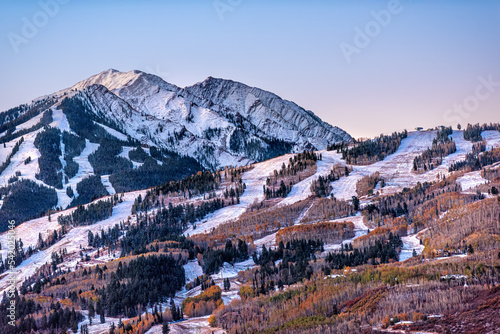 Aerial high angle view of ski resort town city of Aspen, Colorado after winter snow on Buttermilk mountain slopes with valley in autumn fall photo