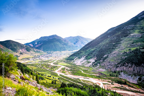 Wide high angle aerial view of Silverton, Colorado small town from overlook at morning sunrise in summer with Mineral creek river, Rocky mountains photo