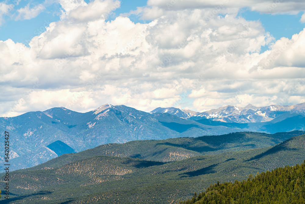 Fototapeta premium Carson National Forest by Sangre de Cristo mountains with green pine trees in summer and peak overlook from route 76 high road to Taos, New Mexico