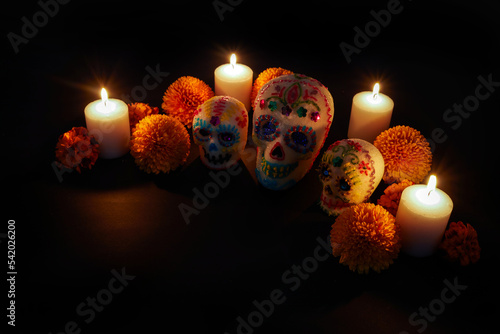 Dia de los muertos - Day of the dead Sugar skull with candles, and cempasuchil flowers altar decoration. photo