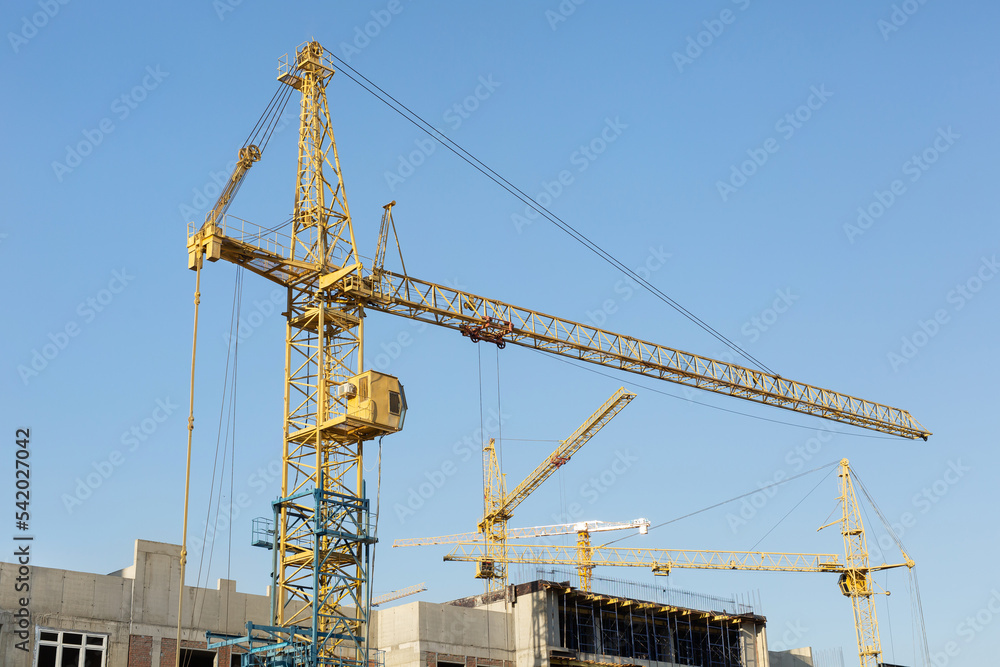 Construction site with crane and building. Construction of a residential multi-storey building.