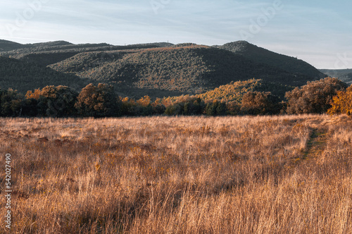 A few hills are bathed in the evening sun. 