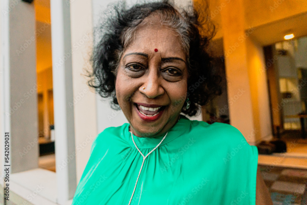 Fototapeta premium An indian elderly dancing and singing at the rooftop