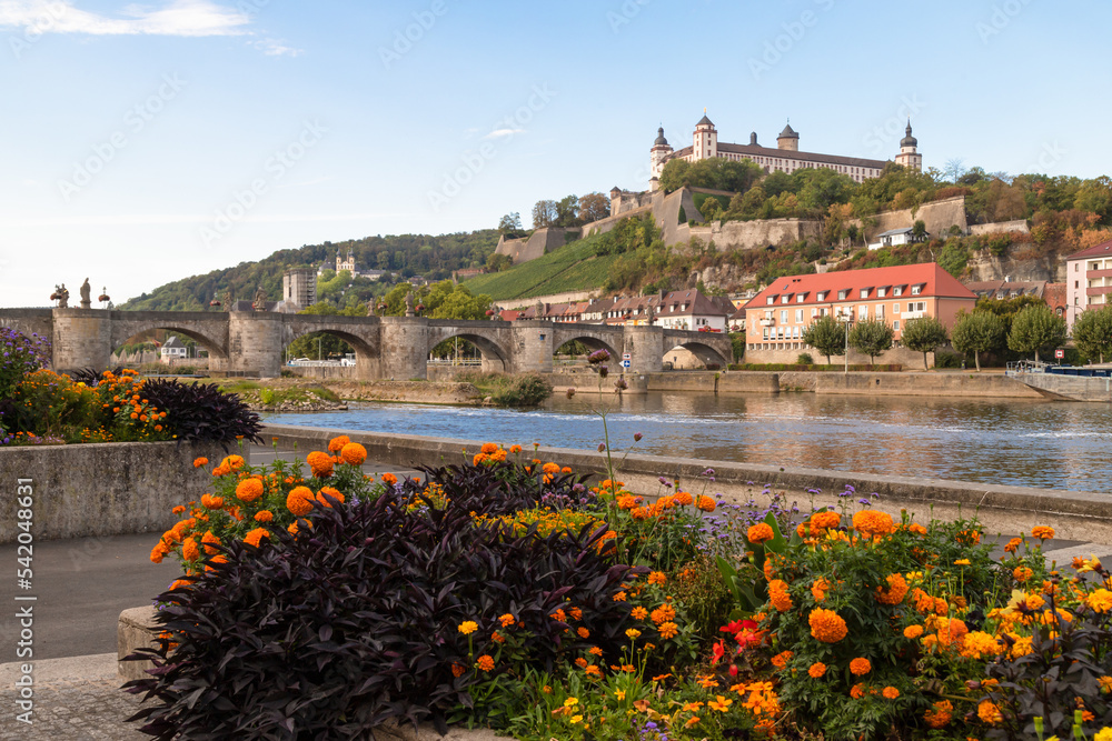 Mainpromenade overlooking the medieval bridge, Alte mainbrücke, and Marienberg fortress in the historic city of Würzburg, Bavaria; Germany.